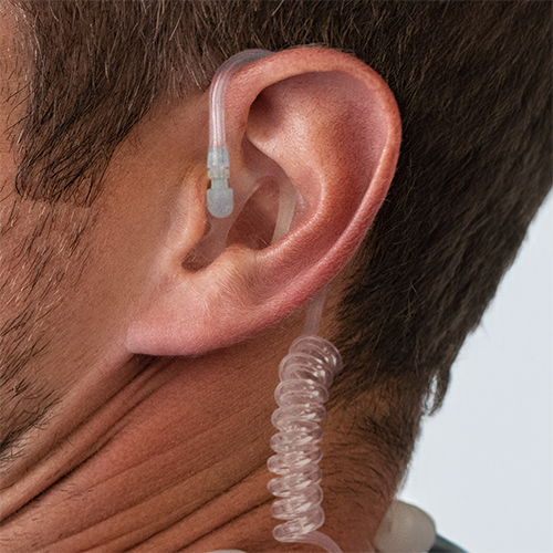 Close-Up of an Ear Wearing a Semi-Custom Earmold Attached to a Coiled Tube