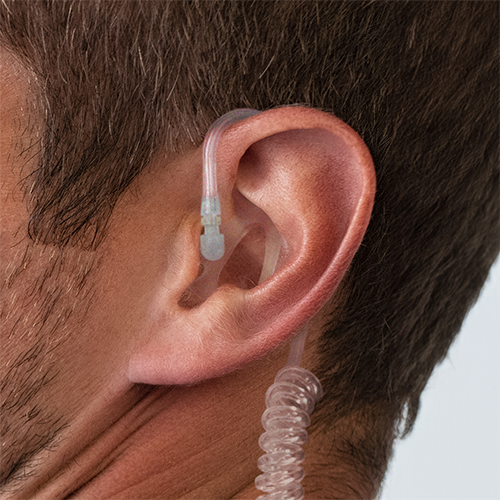 Close-Up Photo of Walkie-Talkie Earpiece with a Coiled Tube and Semi-Custom Earmold Inserted in an Ear
